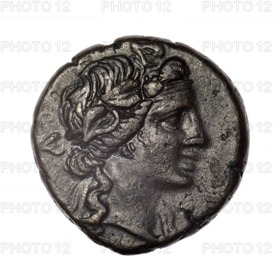Bronze coin, Pantikapaion. Obverse: head of young Dionysus in an ivy wreath facing right. Reverse: bow and arrows in a gorytos with straps, monogram on the left. Iconography: Dionysus, bow in quiver, gorytos, quivers, bows, weapons, armament. Monograms. Date: end of 2nd – ca. mid 1st century BC (time of Mithridates VI Eupator, 120–63 BC). Place: Cimmerian Bosporus, Pantikapaion. Coin. Weight: 17.56 g. Dimensions: 26.8 × 26.9 mm. Maker: Terlecki, Ignacy (1860–1916) noted.