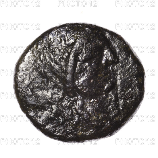 Bronze coin, Pantikapaion; obverse: head of Apollo in a laurel wreath facing right; reverse: eagle with spread wings and head turned back standing on a thunderbolt 3/4 facing left, monogram in the left field, inscription at the bottom. Iconography: eagles, eagle on a thunderbolt, head of Apollo, quivers (armed), birds. Date: after 63 BC. Place: Cimmerian Bosporus, Pantikapaion. Weight: 16.50 g. Dimensions: 25.7 mm and 28 mm.