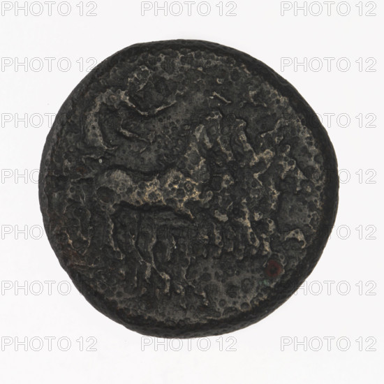 Bronze coin, Chersonesos (Chersonesos Taurica), 350–330 BC. Obverse: Artemis on a quadriga to the right, a torch in the raised right hand, letters at the top. Reverse: naked warrior kneeling to the left, a round shield in the left hand, a spear horizontally in the right, a helmet on the head, XEP at the bottom. Iconography: Artemis, quadriga, kneeling warrior, torch. Weight 6.53 g; axis 210°; dimensions 20.3 × 20.3 mm.