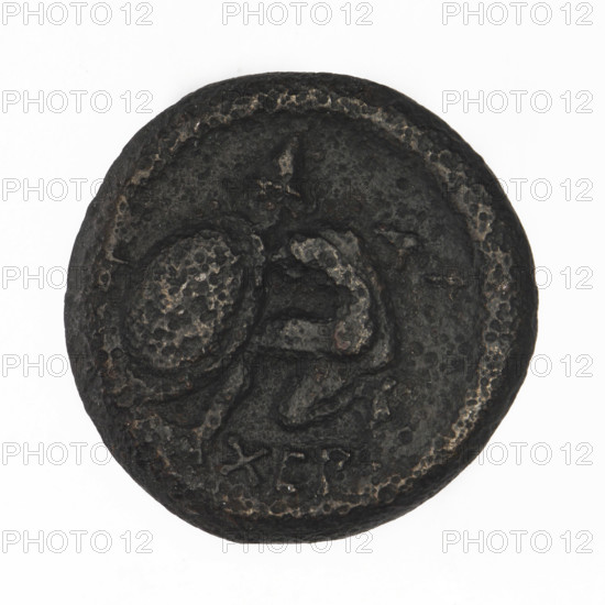 Bronze coin, Chersonesos (Chersonesos Taurica), 350–330 BC. Obverse: Artemis on a quadriga to the right, torch in raised right hand, letters at top. Reverse: naked warrior kneeling to the left, round shield in left hand, spear held horizontally in right, helmet on head, inscription XEP at bottom. Iconography: Artemis on a quadriga, kneeling warrior, warriors, torch. Weight 6.53 g; axis 210°; diameter ~20.3 mm. Maker: Ignatius Terlecki (1860–1916) noted (attribution).