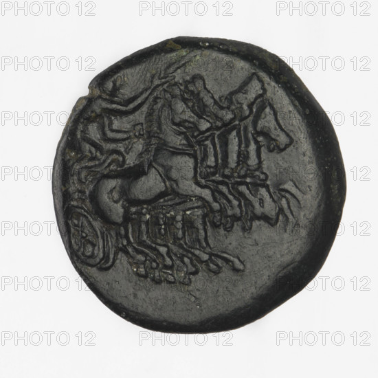 Bronze coin, Chersonesos; obverse: Artemis on a quadriga to the right, a torch in the raised right hand; reverse: naked warrior kneeling to the left, a round shield in the left hand, a spear horizontally in the right hand, a helmet on his head, the letter I in the right field, the inscription XEP (cut-off). Iconography: Artemis on a quadriga, kneeling warrior, torch, carts/quadriga. Date: 350–330 BC. Place: Chersonesos Taurica. Material: bronze. Function: coin. Weight: 6.15 g. Axis: 210°. Dimensions: 20.5 mm × 20.2 mm. Maker/inscription: XEP.