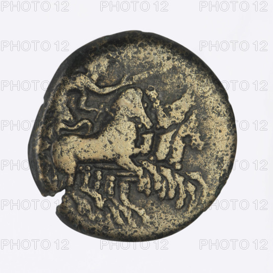 Bronze coin, Chersonesos; obverse: Artemis (Deva) on a quadriga to the right, a torch in her raised right hand; reverse: naked warrior kneeling to the left, a round shield in his left hand, a spear held horizontally in his right hand, helmet on his head, letter M in the right field, inscription XEP (cut-off). Circa 350–330 BC. Chersonesos Taurica. Coin; weight 6.05 g; axis 300°; dimensions approx. 20.2 × 19.6 mm.
