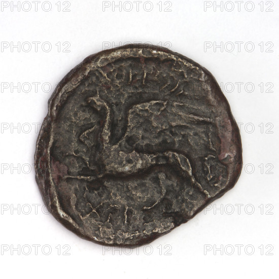 Bronze coin, Chersonesos, 320–310 BC. Obverse: Artemis (Deva) kneeling on right knee facing right, bow in left hand; reverse: eagle-headed griffin to left, official's name at top, XEP at bottom. Materials: bronze; weight 4.14 g; axes 330°; dimensions 21.2 mm × 20 mm. Maker: Chersonesos (Chersonesos Taurica). Related subjects: griffins, kneeling Artemis, Artemis (mythology), Black Sea.