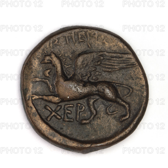 Bronze coin, Chersonesos; obverse: Artemis (mythology) kneeling on right knee to the right, bow in left hand (Artemis with bow and arrow); reverse: eagle-headed griffin to the left, official's name at the top, XEP at the bottom. Date: 320–310 BC. Place: Chersonesos (Chersonesos Taurica), Black Sea. Function: coin. Weight: 7.50 g. Axis: 300°. Dimensions: 21.1 mm x 21.5 mm.
