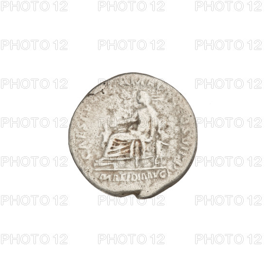 Denarius depicting Marcianna (Trajan's sister; during Trajan's reign 98–117) and Matidia the Elder (Trajan's niece; 68–119) — iconography includes patera, children, and busts. Obv.: bust of Marcianna facing right, hair tied with a necklace, topped with a jewel; rim inscription: MARCIANA AVG SOROR IMP TRAIANI. Rev.: Matidia sits between two children, holding a patera in her right hand, resting her left on a chair; rim inscription: CAES AVG GERMA DAC COS VI PP; legend in the field: MATIDIA AVG. Date: 112–113. Roman Empire (27 BC–476). Coin, weight 2.99 g.