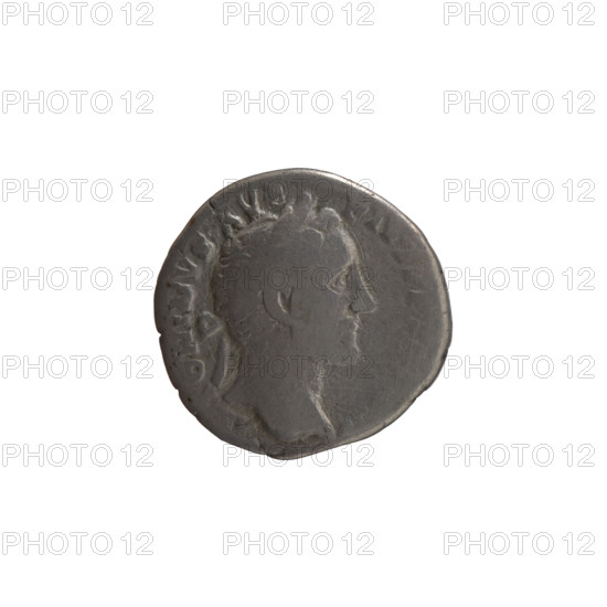 Denarius of Antoninus Pius (86–161; Roman emperor 138–161). Obverse: Head of Antoninus Pius in a laurel wreath facing right, inscription TONINVS AV - PIVS PP TR, VI. Reverse: Annona (personification) stands left, holds ears of corn in her right hand, rests her left on a container (modius) standing on a ship, inscription COS - IIII. Date: 152–153. Place: Rome, Roman Empire (27 BC–476). Medium: coin. Dimensions: diameters 17.5–18.0 mm; weight 3.41 g; axis 180 degrees. Iconography: Antoninus Pius; Annona; ears of corn; modius; ships; personifications.