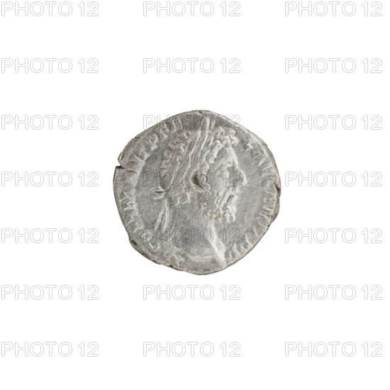 Denarius of Commodus (r. 177–192). Obverse: head of Commodus in a laurel wreath facing right, legend M COMM ANT P FE L AVG BRIT PP. Reverse: Minerva walks right, turns her head left, holds a branch in her right hand and a shield and spear in her left, legend MIN AVG P M TR P X VI COS VI. Date: 190–191. Roman Empire. Coin (silver), diameter 17.0 mm, weight 2.44 g, axis 180°.