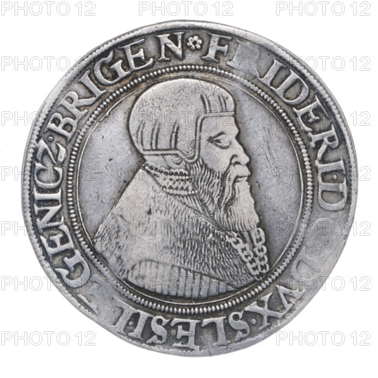 Thaler by Michael Stoltz (fl. ca. 1540–1555) depicting Frederick II, Duke of Brzeg–Legnica (1480–1547). Obverse: male bust turned right with a beard and sideburns, wearing a bonnet and a coat with a wide collar and chain; rim inscription beginning with a rosette FRIDERI.DGDVX.SLESI.LEGENICZ.BRIGEN. Reverse: four-field coat of arms of the Duchy of Legnica–Brzeg topped with a jewel with labres; rim inscription VERBVM.DOMINI.MANET.IN.ETERNVM.I546. Dated 1546. Silesia, Duchy of Brzeg–Legnica–Wolów, Legnica. Coin — diameter 41.0 mm; weight 28.96 g; axis 180°.
