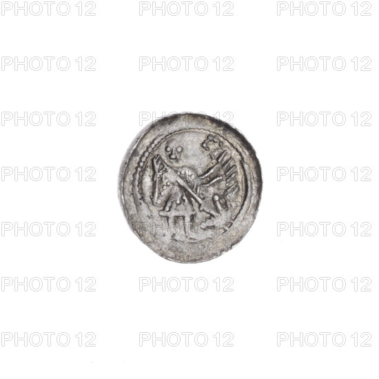 Denarius of Boleslaw III Krzywousty (prince of Poland; c. 1107–1138). Obverse: in the beaded border, a knight in chain mail thrusting a spearhead into the jaws of an inverted dragon. Reverse: in the triple beaded border, an isosceles cross topped with spheres; between its arms two spheres (one dot on each) and two suns. Allegorical imagery includes knights, dragons, martyrs, fight against pagans, fight between good and evil; motifs: equal-armed cross, spearhead (issue mark), spears, chain mail, mouths. Romanesque style. Possible association with Saint Adalbert. c. 1125–1138. Poland, Kraków. Coin (denarius). Diameter: 12.8–13.1 mm. Weight: 0.60 g.