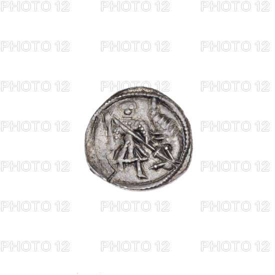 Denarius of Boleslaw III Krzywousty (prince of Poland; c. 1125–1138). Obverse: within a beaded border, a knight in chain mail thrusting a spearhead into the jaws of an upside-down dragon (knight in chain mail, spear, dragon; allegory of fight between good and evil / fight against pagans; Romanesque style; references to martyrs/Adalbert). Reverse: within a triple beaded border, an isosceles cross topped with crossbars; between its arms radiate two spheres (smaller ones nearer the center, larger ones each with a single dot). Silver coin (denarius), diameter ~12.7–12.9 mm, weight 0.65 g; Poland, Kraków.