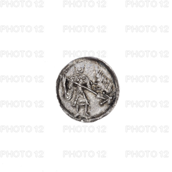 Denarius, Boleslaw III Krzywousty (Prince of Poland; r. 1107–1138). Obverse (in beaded border): a knight in chain mail thrusting a spearhead into the jaws of an upside-down dragon. Reverse (in triple beaded border): an isosceles cross terminated with crossbars, a dot at the crossbar intersection; between the arms, radiating spheres (smaller ones near the center, larger ones—three with a dot each). Motifs: allegories, martyrs, knight, dragons, fight against pagans, fight between good and evil; iconographic references to Adalbert (Saint, ca. 956–997). Romanesque style. Issue mark: spearhead. Date: c. 1125–1138. Place: Poland, Kraków. Coin; diameter 12.3–12.8 mm; weight 0.54 g.