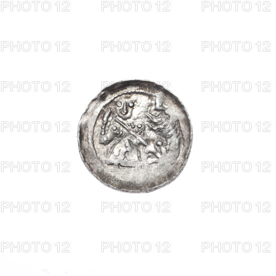 Denarius of Boleslaw III Krzywousty (prince of Poland; reign 1107–1138). Obverse: within a beaded border, a knight in chain mail thrusting a spearhead into the jaws of an upside-down dragon. Reverse: within a triple beaded border, an isosceles cross topped with balls (three with a central dot; the fourth area poorly struck), between the arms a sun (two with a central dot; remaining areas poorly struck). Romanesque style; themes: dragons, fight between good and evil, fight against pagans, martyrs, Saint Adalbert. Issued ca. 1125–1138, Kraków, Poland. Coin (denarius), diameter 12.9–13.1 mm, weight 0.61 g.