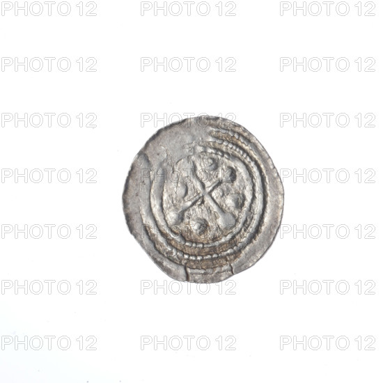 Denarius, Boleslaw III Krzywousty (prince of Poland; 1086–1138). Obverse: in a beaded border, a knight in chain mail thrusting a spearhead into the jaws of an upside-down dragon. Reverse: in a triple beaded border, an isosceles cross topped with spheres (two with one dot each); between its arms, one quarter with two radiating spheres (one smaller near the center, one larger) and the three remaining quarters with one sphere each. Iconography: spearhead, chain mail, crosses, jaws, dragon, knight, martyrs, Adalbert (Saint; ca. 956–997), spears, fight between good and evil; Romanesque style; fight against pagans. Date ca. 1125–1138; Poland, Kraków. Coin (denarius). Diameter 12.7–13.5 mm; weight 0.61 g.