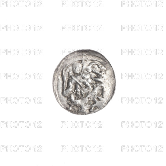Denarius, Boleslaw III Krzywousty (prince of Poland; 1086–1138). Obverse: in the linear border, a knight in chain mail thrusting a spearhead into the jaws of an upside-down dragon. Reverse: in the triple beaded border, an isosceles cross topped with spheres (two of them with one dot each; other portions blurred), with two spheres radiating between its arms (smaller nearer the center, larger with one dot each). Iconography: spearhead, crosses, chain mail, jaws, knight, dragon, martyrs, fight between good and evil, fight against pagans; Romanesque style. Date: ca. 1125–1138. Place: Kraków, Poland. Coin (denarius). Diameter: 11.9–12.3 mm. Weight: 0.35 g.