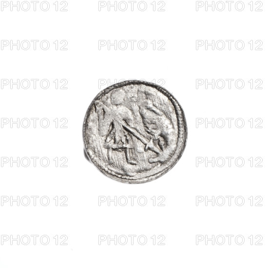 Denarius of Boleslaw III Krzywousty (prince of Poland; reign 1107–1138). Obverse: in a beaded border, a knight in chain mail thrusting a spearhead into the jaws of an upside-down dragon. Reverse: in a triple beaded border, an isosceles cross topped with balls; between its arms, one ball. Attributes/subjects: allegories; equal-armed cross; crosses; chain mail; spearhead (issue mark); martyrs; knight; Romanesque style; dragons; mouths; dragon; Middle Ages; Adalbert (Saint; ca. 956–997); spear; fight between good and evil; fight against pagans. Date: ca. 1125–1138. Place: Kraków, Poland. Object type: coin (denarius). Diameter: 11.8–12.2 mm. Weight: 0.43 g.