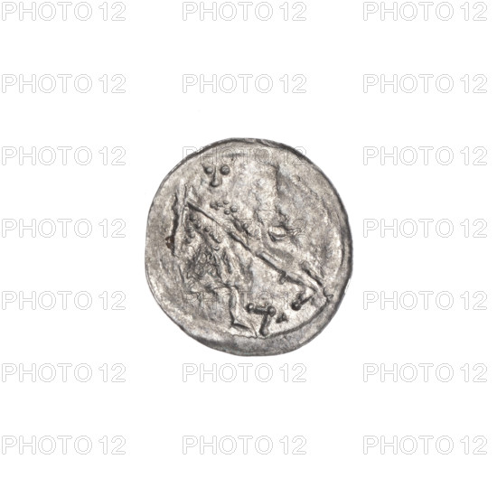 denarius, Boleslaw III Krzywousty (prince of Poland; 1086–1138), Romanesque, c. 1125–1138, Poland, Kraków; coin; diameter 12.8 mm; weight 0.36 g. Obv.: in a beaded border, a knight in chain mail thrusting a spearhead into the jaws of an upside-down dragon; at the knight's left foot, a figure resembling the number '7' angled toward the foot, its vertices marked with dots. Rv.: in a triple beaded border, an isosceles cross topped with balls; between its arms one ball (three of them have one dot); one arm intersects the other at approximately 1/3 of its length. Iconography: spearhead, chain mail, equal-armed cross, chains/crosses, mouth, knight, martyrs, dragons, mouths, Adalbert (Saint; ca. 956–997), fight between good and evil, spear/spears, fight against pagans.