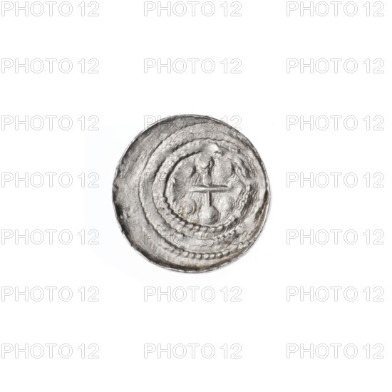 Denarius, Boleslaw III Krzywousty (prince of Poland; 1086/1107–1138). Obverse: in a linear border, a knight in chain mail thrusting a spearhead into the jaws of an upside-down dragon. Reverse: in a triple beaded border, an isosceles cross topped with balls (some balls with one dot each); between its arms, balls (some dotted)—partly obscured by under-striking. Attributes/subjects: equal-armed cross, spearhead (issue mark), chain mail, crosses, jaws, knight, martyrs, Romanesque style, dragons, dragon, Middle Ages, knights, fight between good and evil, fight against pagans, Adalbert (St.; ca. 956–997), spears/spear. Date: ca. 1125–1138. Place: Kraków, Poland. Medium/function: coin. Diameter: 12.3–12.6 mm. Weight: 0.56 g.