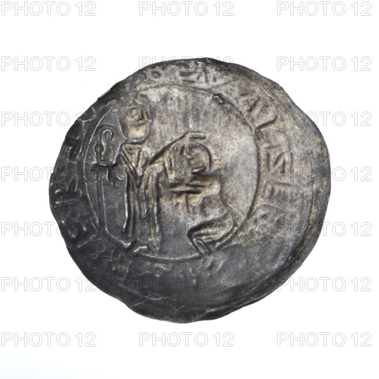 Bracteate, 1135–1138. In a pearl border, on the left, facing right, a kneeling prince (Boleslaw III Krzywousty, Prince of Poland, 1086–1138) shown in profile with hands outstretched toward a bishop. Dressed in liturgical vestments, Saint Adalbert (ca. 956–997) holds a crosier in his left hand while his right hand rests on the prince's head. Around the rim, in a linear border, inscription: +•L•R:EBBEZLAVS. Romanesque style; iconography includes gesture of protection, bishops, martyrs. Coin (bracteate), diameter 26.0–27.8 mm, weight 0.58 g.