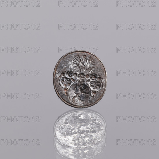 Sealing wax stamp - keyring, sealing wax stamps, Lion (coat of arms). Oval sealing wax stamp with a decorative handle and a hole for hanging on a belt. In the oval field, a circular cartouche with a mounted lion with a raised tail is set on a column. Rich labyrinths in the form of floral wreaths. In the jewel above the closed tournament helmet, between two eagle wings, the coat of arms is repeated (Lew VI variety). Late 18th–early 19th century, Poland. Seal; height 21 mm, width 22 mm, depth 20 mm.