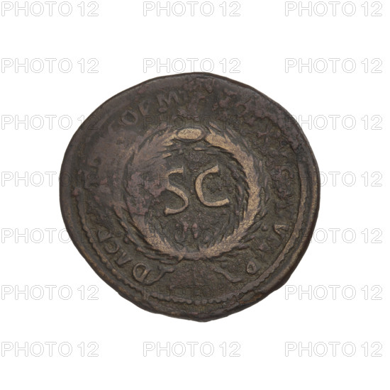 Countermarked coin of Trajan (53–117; Roman Emperor 98–117). Obverse: head of Trajan in radiant crown facing right; rim inscription 'IMP CAES NER TRAIANO OPTIMO AVG GERM'. Reverse: letters 'SC' surrounded by an oak wreath; rim inscription 'DAC PARTHICO PM TR POT XX COS VI PP'. Bucranium countermark, probably applied when Trajan's troops were retreating from Parthia. Date: 114–117. Roman Empire (27 BC–476). Cyprus. Oak wreaths, radiant crowns, heads. Coin; weight 9.46 g.