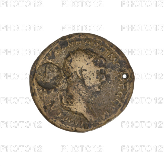 Countermarked; Trajan (53–117; Roman Emperor 98–117). Obverse: head of Trajan in radiant crown facing right; rim inscription IMP CAES NER TRAIANO OPTIMO AVG GERM. Reverse: letters SC surrounded by an oak wreath; rim inscription DAC PARTHICO PM TR POT XX COS VI PP. Bucranium (ox skull) countermark, probably made when Trajan's troops were retreating from Parthia. Pierced coin, 114–117. Material: coin; weight 8.85 g. Roman Empire (27 BC–476).