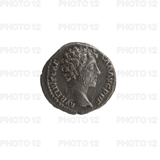 Denarius, Marcus Aurelius (121–180; Roman emperor 161–180), (caesar 139–161); issuer: Antoninus Pius (86–161; Roman emperor 138–161). Obverse: Head of young Marcus Aurelius without a cap to the right, inscription AVRELIVS CAE SAR AVG PII F. Reverse: Minerva stands right, holding a spear in her raised right hand, left hand rests on a shield on the ground, inscription TR P OT III COS II. Roman deities iconography; shields, spears. Date: 148–149. Roman Empire (27 BC–476), Rome. Coin: diameter 17.5–18.5 mm, weight 2.66 g, axis 180 degrees.