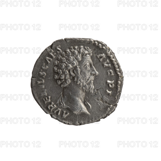 Denarius, Marcus Aurelius (121–180; Roman emperor 161–180), Caesar 139–161; Antoninus Pius (86–161; Roman emperor 138–161) — issuer; Antoninus Pius (86–161; Roman emperor 138–161), Marcus Aurelius (heir to the throne 138–161) — iconography: helmets, personifications, parazonium (attribute), Virtus (personification), spears. Obverse: Head of Marcus Aurelius bare, with drapery on the left shoulder, right; inscription AVREVS CAES-AVG PI. Reverse: Virtus standing right with left foot on a fallen helmet, holding a spear pointed down in his right hand and a parade dagger (parazonium) in his left; inscription TR POT XIII — COS II. Date: 158–159. Roman Empire (27 BC–476), Rome. Coin: diameter 17.0–18.0 mm, weight 2.80 g, axis 180°.