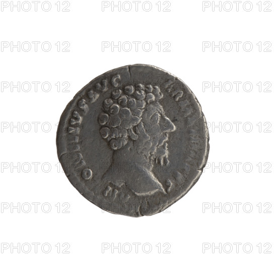 Denarius; issuer: Marcus Aurelius (121–180; Roman emperor 161–180). Obverse: Head of Marcus Aurelius without a cap facing right, inscription N O NVS AVG - ARMEN, CVS (around). Reverse: Mars standing right, holding a spear with the point down in his right hand, resting his left hand on a shield, inscription PM TR P XVIII - IMP II COS III (around). Date: 163–164 CE; Culture: Roman Empire (27 BC–476). Place: Rome. Subject/iconography: Marcus Aurelius; Mars (mythology); Roman deities; shields; spears. Object type/material: coin (denarius). Dimensions/weight: diameter 16.5–17.5 mm, weight 2.70 g, axis 180°.