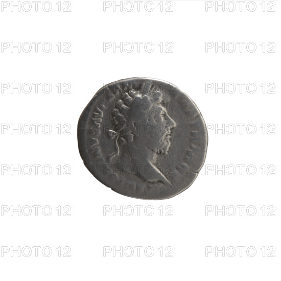 Denarius of Marcus Aurelius (121–180; Roman emperor 161–180). Obverse: Head of Marcus Aurelius with laurel wreath facing right, inscription ANTONINVS AV. Reverse: Victoria stands half-naked frontally, head turned right, holding a palm branch in her right hand and fastening a shield inscribed VIC PAR to a tree with her left hand; inscriptions TR P XX – IMP IIII COS III. Iconography: Victoria, palm branches, shields, Roman deities; portrait and imperial titles. Date: 166. Place: Roman Empire, Rome. Material/format: coin (denarius). Dimensions: diameter 19.5 mm; weight 2.95 g; axis 0°.