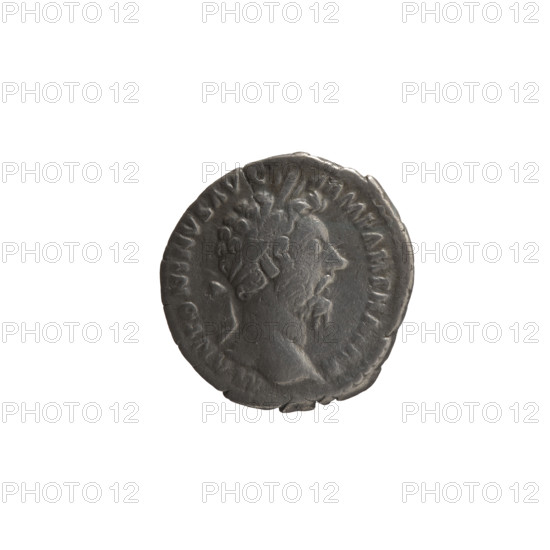 Denarius of Marcus Aurelius (121–180; Roman emperor 161–180). Obverse: Head of Marcus Aurelius in a laurel wreath facing right; inscription M ANTONINVS AVG - ARM PARTH MAX. Reverse: Victoria stands half-naked frontally, head turned right, holding a palm branch in her right hand and fastening a shield inscribed VIC PAR to a tree with her left hand; inscription TR P XX IMP I - III COS III. Date: 166. Roman Empire (27 BC–476), Rome. Coin: silver denarius, diameter 18.0 mm, weight 2.48 g, axis 0°.