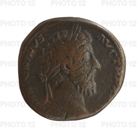 Sestertius of Marcus Aurelius (121–180; Roman emperor 161–180), issuer: Marcus Aurelius. Obverse: head of Marcus Aurelius with laurel wreath facing right, legend 'M ANTONINVS - AVG TR P XX' all around. Reverse: Roma personified seated on armor facing left, holding a scepter in her right hand and resting her left on a stack of shields; legend 'MP VI - CO, III' all around, 'IN SC' in fields. Date: 171–172. Roman Empire (27 BC–476). Coin: bronze; diameter ~29–30 mm, weight 19.50 g, axis 195°.