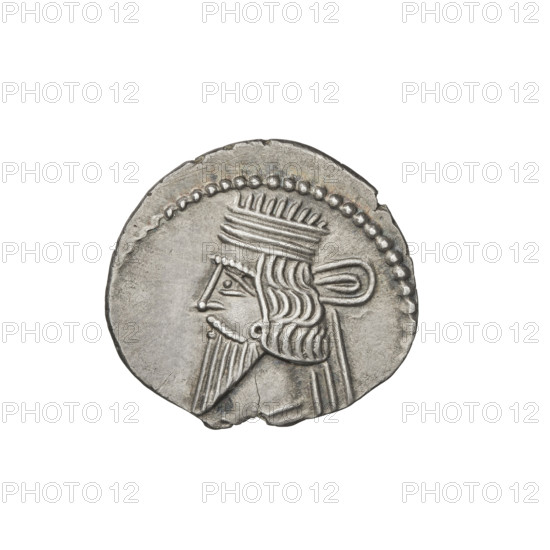 Drachma of Vologases I (51–79). Obverse: bust of Vologases I facing left, wearing a diadem, with a long beard and decorated robe. Reverse: Arsakes seated on a throne facing right, holding a bow; monogram below the bow. Iconography includes busts, diadems, bows (armed). Parthian Kingdom (Parthia), Iran. Coin; diameter 19.0–20.0 mm; weight 3.58 g.