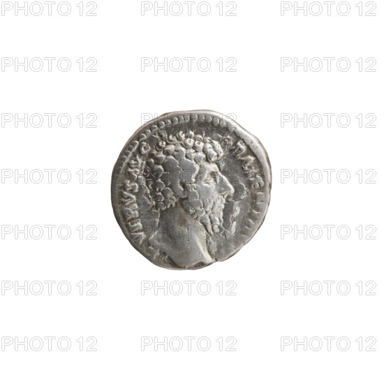 Denarius of Lucius Verus (130–169; Roman emperor 161–169). Obverse: Head of Lucius Verus without a cap to the right, legend 'L VERVS AVG - ARMENIA' all around. Reverse: Mars stands to the right, holds a spear in his right hand, rests his left on a round shield standing on the ground, legend 'TR P V - IMP II C, S II' all around. Date: 164–165. Roman Empire (27 BC–476), Rome. Coin: silver denarius; diameter 16.0–16.5 mm, weight 3.05 g, axis 0°. Iconography: Roman deities (Mars), shields, spears.