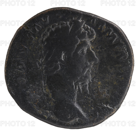 Sestertius of Lucius Verus (130–169; Roman emperor 161–169). Obverse: Head of Lucius Verus with laurel wreath facing right, inscription VERVS AVG - ARM PARTH M. Reverse: Parthian prisoner sitting under a trophy facing right, hands tied behind his back, with a bow, quiver, and shield beside him, inscription TR POT V - IMP III COS II in SC fields. Date: 165. Place: Rome, Roman Empire (27 BC–476). Coin; diameter 29.0–31.0 mm, weight 22.20 g, axis 180°.