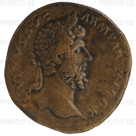 Sestertius of Lucius Verus (130–169), Roman emperor 161–169. Obverse: head of Lucius Verus with laurel wreath facing right, inscription L VERVS AVG - ARM PARTH MAX. Reverse: Parthian prisoner sitting under a trophy facing right, hands tied behind his back, shield in front, inscription TR POT VI - IMP III COS II, in SC fields. Date: 165–166. Roman Empire (27 BC–476), Rome. Coin; diameter 31.5–33.0 mm, weight 23.87 g.
