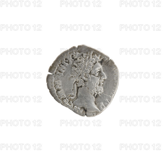 Denarius of Commodus (161–192; Roman emperor 177–192). Obverse: Head of Commodus in a laurel wreath facing right, inscription M COMM ANT PF - AVG B, T PP. Reverse: Naked Apollo standing right, left hand resting on a column, right hand behind his head, inscription POL - MONE -, PM TR P XV, with fields COS - V, 190. Roman Empire (27 BC–476), Rome. Coin. Diameter 16.0–18.0 mm, weight 1.80 g, axis 180°.