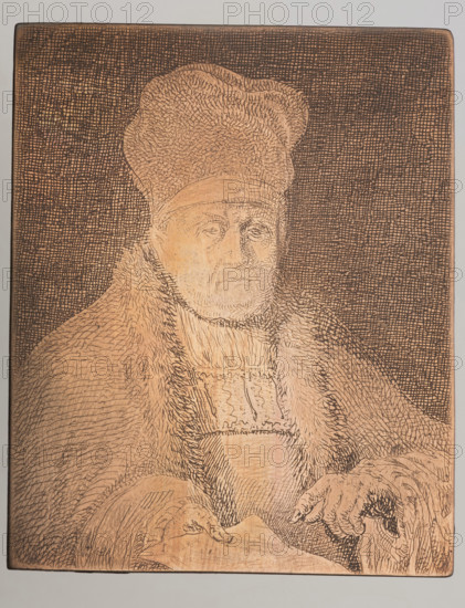 Bust of a church dignitary; Jean Pierre Norblin de la Gourdaine (1745–1830), graphic artist; Dominik Witke-Jezewski (1862–1944). French, Polish; portraits of clergy; male portrait; print. Hillemacher gives 2 states of this engraving: 1 — head covered with a cap; 2 — in a high hat. A print exists as in state 2 with a more elaborated (plasticized) form and a very clear date, 1784. Graphic matrix/plate. Dimensions: height 5.8 cm, width 4.8 cm, thickness 0.1 cm., A rectangular etched plate showing a portrait of an older person wearing a tall hat and a heavy fur-lined robe, rendered with fine crosshatching and short strokes. The figure faces slightly toward the viewer with a neutral facial expression, visible eyes, nose, and mouth created by detailed incised lines. The hat has textured, curved marks, and the robe shows dense fur-like strokes around the collar and sleeves. The person's hands rest in front, one touching a flat surface or draped cloth, with visible finger lines and shading. Th...