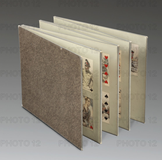 Solitaire - cards from the first two years of the European War, Tanski, Czeslaw (1862-1942), illustrator, playing cards, collectible stamps, games, Poland, World War I (1914-1918). The album 'Patience' consists of 53 playing cards with depictions related to World War I. The cards symbolically depict the countries participating in the war: their rulers, the commanders-in-chief of the individual armies, as well as warfare and its effects, such as the spraying of poison gas, soldiers manning anti-aircraft guns, the migration of displaced persons, and a field hospital set up in a church. The individual card suits correspond to the different powers: spades refer to Germany and Austria-Hungary, hearts represent France and Belgium, clubs symbolize Great Britain, and diamonds represent Russia. The last card in the deck is devoid of any suits, and therefore, of any associations with the warring powers. It is an allegory of Peace – a woman in a white dress holding a branch in her hand, smashing ...