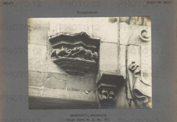 Corrugated stones of the Gemeenlandshuis on the Oude Delft in Delft decorated with fantasy creatures, Gemeentelandshuis. Oude Delft WZ No. 167. Corrugated stones, photograph, number: '16', inscription: 'The right of reproduction of these photos is reserved by the Publisher.', inscription: 'Delft. Early 16th century.', Delft, c. 1900 - c. 1904, photographer, paper, pasteboard, gelatin silver print, height 115 mm x width 155 mm, ornament, hybrid animals, Gemeenlandshuis, A grayscale photograph of a stone facade with carved architectural details showing a recessed decorative shelf with layered zigzag moldings and a central sculpted relief that appears folded and draped, set within large rectangular stone blocks; to the right a vertical column of stone features a rounded carved volute and flowing scroll-like ornamentation, and below the shelf a corbel with two small carved humanlike heads supports another projecting element; the image is bordered by a dark matte with narrow visible edges.