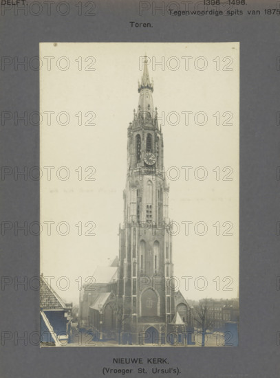 View of the Nieuwe Kerk in Delft, Nieuwe Kerk. (Formerly St. Ursul's). Tower, photograph, inscription: 'The right of reproduction of these photos is reserved by the Publisher.', number: '7', inscription: 'Delft. 1396-1496. Present spire of 1875.', Delft, c. 1900 - c. 1904, photographer, paper, pasteboard, gelatin silver print, developed gelatin silver print, height 166 mm x width 108 mm, church (exterior), parts of church exterior and annexes: tower, Nieuwe Kerk (Delft), A tall Gothic church tower with pointed spire and ornamental pinnacles rises from a large stone church building, showing arched windows, buttresses, a clock face on the tower, and an arched main entrance; surrounding the church are rooftops of nearby buildings, bare trees, and a street visible at the base, all presented within a pale rectangular photograph mounted on a dark textured background.