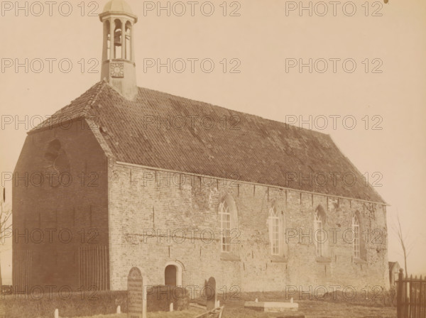 View of the Reformed Church in Rottum, photograph, annotation: 'Rottum, gem. Kantens', annotation: 'NH church in Rottum, Rottum, 1890 - 1910, photographer, Attributed to, paper, pasteboard, albumen print, height 174 mm x width 231 mm, church (exterior), A sepia-toned photograph of a brick building with a steep tiled roof and a small belfry rising from the roofline, the belfry showing open arches and a visible bell, the building’s side wall featuring tall arched windows and a lower arched doorway, the foreground showing a grass area with several upright gravestones and a low rectangular grave marker, and a simple wooden fence visible at the right edge.