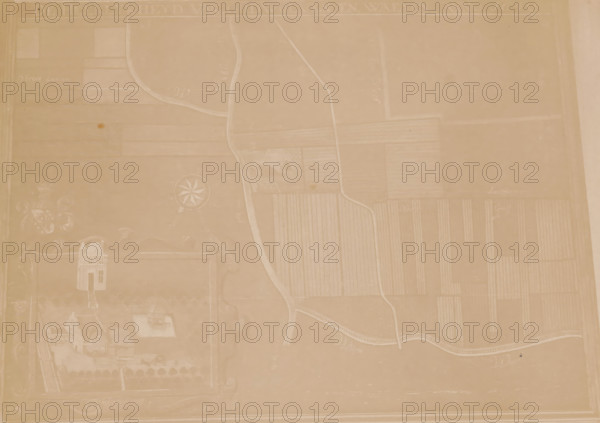 Photo reproduction of a map of the municipality of Houten, photograph, reproduction, annotation: 'AA 224', annotation: 'gem. Houten, Utr.', after design by anonymous, 1890 - 1920, photographer, Attributed to, paper, pasteboard, albumen print, height 147 mm x width 206 mm, maps, atlases, Houten, A faded, sepia-toned map-like image showing a large rectangular area with faintly drawn fields divided by narrow paths and curved roads, a winding river or stream running vertically through the composition, a circular compass rose shape near the left-center, decorative scrollwork and a small illustrated building grouped toward the lower-left, faint outlines of rectangular plots with parallel lines indicating cultivated land across the right side, and a pale border framing the entire image.