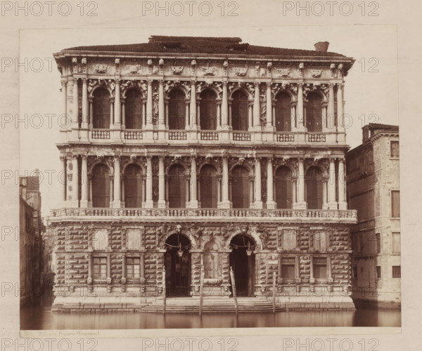 Palazzo Pesaro (Venezia), View of the Palazzo Pesaro in Venice, Italy, photograph, inscription: 'Pl. 9 style h', number: '32', inscription: 'II', inscription: 'pal Pesaro in Venice, ...', number: 'No. 3529.', collector's mark: 'RIJKS SCHOOL FOR ART NIJVERINGEN, GROEP', photographer: attributed to Giorgio Sommer, Venice, 1857 - 1914, Giorgio Sommer, photographer, Attributed to, pasteboard, paper, albumen print, albumendruk, height 321 mm x width 479 mm, hôtel, ie small palace in city, Ca' Pesaro, A large ornate stone façade with multiple levels of arched windows and columns faces a calm canal, showing decorative sculptures and reliefs between the columns and above the arches; the lower section features rusticated masonry with square protruding blocks, two tall arched doorways with decorative surrounds and a central fountain basin flanked by stone steps leading down to the water, where wooden mooring poles rise from the canal; the upper stories display paired columns, balustrades, and sc...