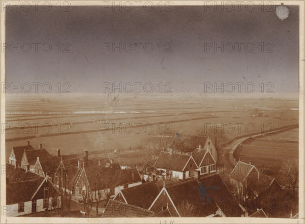View of Oosterend in Texel, photograph, annotation: '13 1, 2', annotation: 'Oosterend, Texel', Oosterend, 1890 - 1910, photographer, Texel, paper, pasteboard, daylight collodion silver print, lithography, daylight collodion silver print and lithography, height 120 mm x width 165 mm, height 220 mm x width 270 mm, agriculture, village, A sepia-toned aerial view shows a cluster of pitched-roof houses and buildings in the foreground with visible chimneys, windows, and roof tiles, some trees without leaves scattered among them, fences and narrow pathways between the structures, and laundry or cloth hanging on a line near one house; beyond the houses stretches a flat, open landscape of fields and waterways with linear dikes and meandering roads, a few small isolated structures in the distance, and a wide sky above that fades from darker tone at the top to lighter near the horizon.