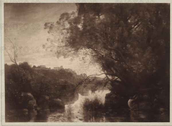 Photo reproduction of a painting by Camille Corot (landscape), photograph, publisher: Adolphe Braun & Cie., 1880 - 1900, pasteboard, paper, carbon print, paper on cardboard, height 270 mm x width 375 mm, Person, Camille Corot, A sepia-toned landscape showing a river reflecting light and surrounded by dense trees and foliage, with a large overhanging tree on the right whose branches extend across the scene and finer branches and leaves silhouetted against a lighter sky, a distant hillside with clustered buildings and rooftops visible along the horizon to the left, marshy plants and reeds growing at the water’s edge, rocky banks and shadowed undergrowth in the foreground, and varied textures of leaves and bark throughout the composition.