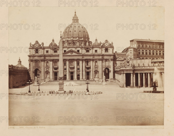 View of St. Peter's Basilica from St. Peter's Square in Rome, ROMA Chiesa di S. Pietro, photograph, number: '1002', St. Peter's Square, c. 1875 - c. 1900, photographer, Vatican City, paper, pasteboard, albumen print, height 197 mm x width 250 mm, monument, statue, square, circus, church (exterior), St. Peter's Basilica, A wide sepia photograph shows a large classical façade topped by a prominent dome with ornate detailing and statues along the roofline. In front of the building a tall obelisk rises from a square, flanked by lamp posts and low bollards arranged across a paved plaza. The façade features multiple columns, arches, and rectangular windows, with steps leading up to the main entrances. Statues stand on pedestals near the building and along the perimeter colonnades. To the right a long colonnade with high columns and an upper row of windows extends alongside the square, and a fountain with a vertical jet is visible near the colonnade. Smaller architectural elements, sculptural...
