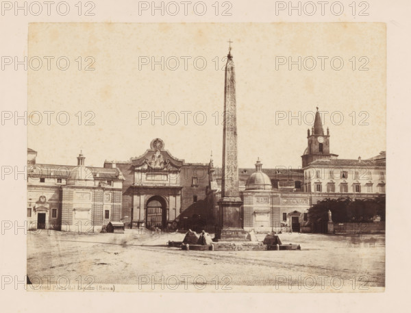 View of Porta del Popolo and the Flaminische Obelisk in Rome, Porta del Popolo (Roma), photograph, number: 'No. 1009.', Rome, c. 1875 - c. 1900, photographer, paper, pasteboard, albumen print, height 178 mm x width 237 mm, square, circus, city-gate, obelisk, needle, A wide sepia photograph of a plaza featuring a tall, narrow obelisk with carved markings standing on a stepped stone base and topped with a small cross, flanked by classical buildings with domed roofs and decorative facades, an arched gateway with sculptural ornament above it, a rectangular building with a clock tower and spire to the right, and a small statue on a pedestal near a group of trees, all set on a broad open paved foreground.