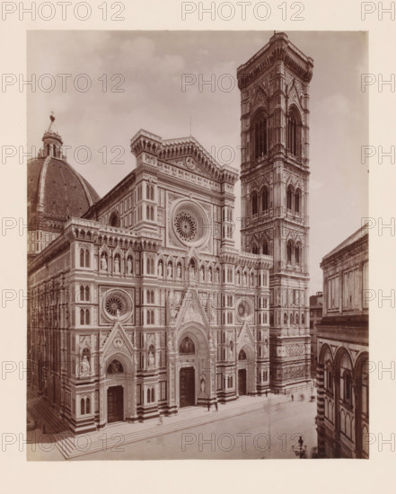 Facciata della Cattedrale, Prof. The Fabris, Porch and campanile of the Cathedral of Florence, Italy, Firenze, photograph, number: '5407.', number: '72', photographer: Giacomo Brogi (possibly), Florence, publisher: attributed to Edizioni Brogi, 1864 - 1881, Tuscany, Attributed to, pasteboard, paper, albumen print, height 444 mm x width 318 mm, church (exterior), tower (or house or building), Florence Cathedral, Campanile (Florence), A photographic view of an ornate cathedral façade and a tall freestanding bell tower, both showing layered stonework and decorative arches, circular rose windows set into the façade, triangular pediments above doorways, rows of niches with statues, patterned marble panels in contrasting tones, and vertical pilasters; a large domed roof with a lantern and cross is visible to the left, while a lower adjacent building with arched openings appears at the right edge; broad stone steps lead up to the cathedral entrances and a few small indistinct figures and a la...