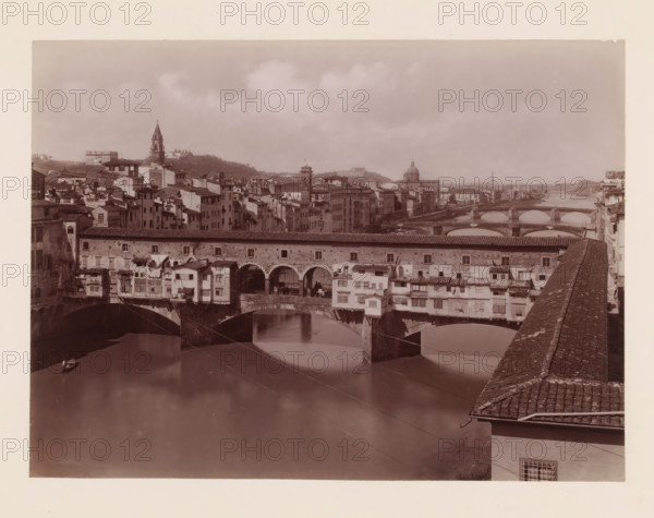 Ponte Vecchio, rifondato nel 1355 coll'opera di Taddeo Gaddi, Ponte Vecchio over the Arno in Florence, Italy, Firenze, photograph, number: '10.', number: '3066.', photographer: Giacomo Brogi (possibly), Florence, publisher: attributed to Edizioni Brogi, 1864 - 1881, Giacomo Brogi, Edizioni Brogi, photographer, publisher, Tuscany, Attributed to, pasteboard, paper, albumen print, height 317 mm x width 445 mm, landscape with bridge, viaduct or aqueduct, river, bridge in city with structures, ie shops, houses, eg Ponte Vecchio in Florence, A sepia-toned view of a city river scene with an arched stone bridge foregrounded, buildings with tiled roofs and small projecting rooms lining the bridge, and reflective water beneath the arches; a row of multi-story buildings and towers stretches along the far bank, a domed structure and a tall pointed bell tower rise among the clustered rooftops, additional arched bridges cross the river farther downstream, and a stone parapet with tiled top runs alon...