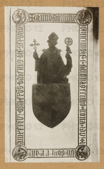 Tomb of Lamprecht von Brunn in Bamberg Cathedral, Grabplatte d. Bischofs Lambert v. Brun (1398), album page, photograph, This photo is part of an album., number: '161', Bamberg, 1900 - c. 1920, photographer, Bavaria, paper, baryta paper, gelatin silver print, height 224 mm x width 135 mm, Person, Lamprecht von Brunn, interior of church, Bamberg Cathedral, A centered metal effigy of a robed bishop wearing a mitre and holding a cross in one hand and a crozier in the other is depicted against a light rectangular panel framed by patterned borders; the bishop's robes show carved drapery lines and a decorative collar, and beneath the effigy is a large shield bearing divided heraldic designs including a diagonal band and animal motifs. The surrounding border contains circular medallions at the corners with stylized bird figures and repeated ornamental vertical bands along the sides, all set on a lighter background with a darker outer margin.